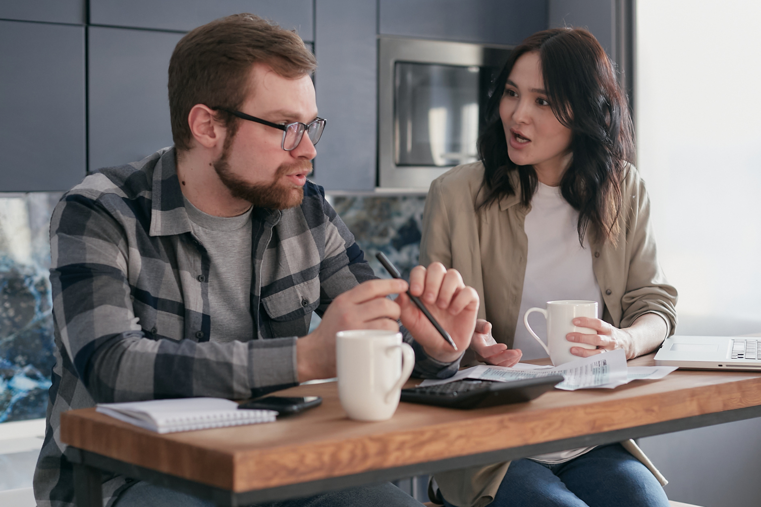 a husband trying to explain things to his wife, while she looks as him in disagreement